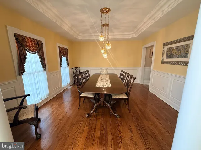 a view of a dining room with furniture wooden floor and chandelier