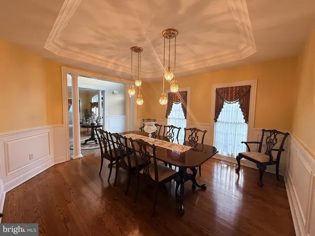 a view of a dining room with furniture wooden floor and chandelier