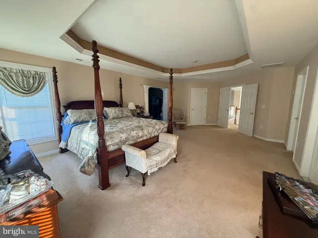 a bed room with a bed and a chair