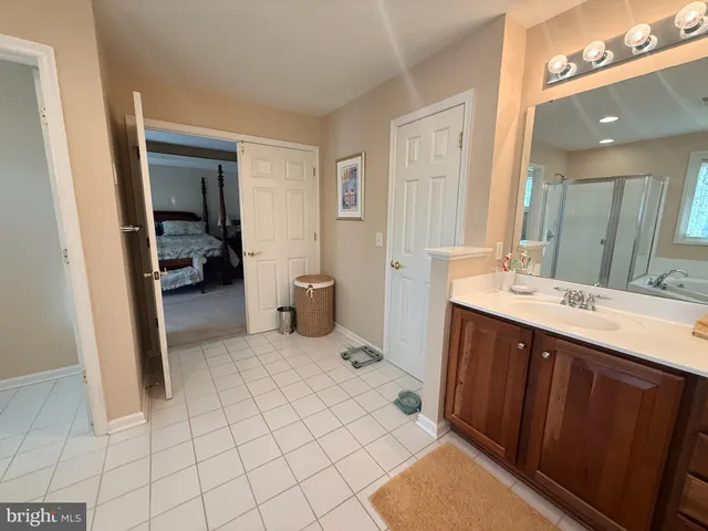 a bathroom with a sink vanity and mirror