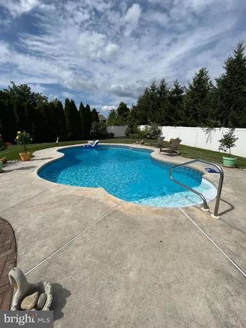 a view of a swimming pool with a yard