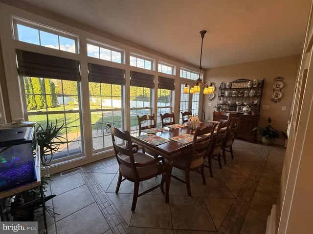a view of a dining room with furniture window and outside view