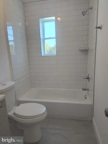 a bathroom with a toilet and shower