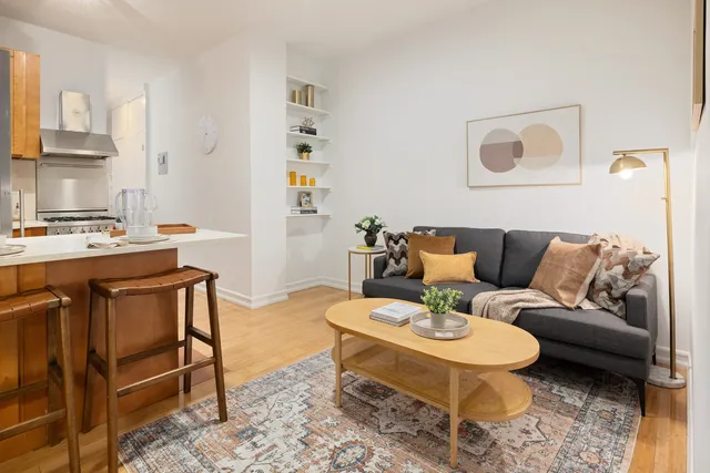 a living room with furniture a rug and a table