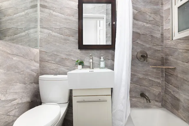 a bedroom with a bed and a night stand