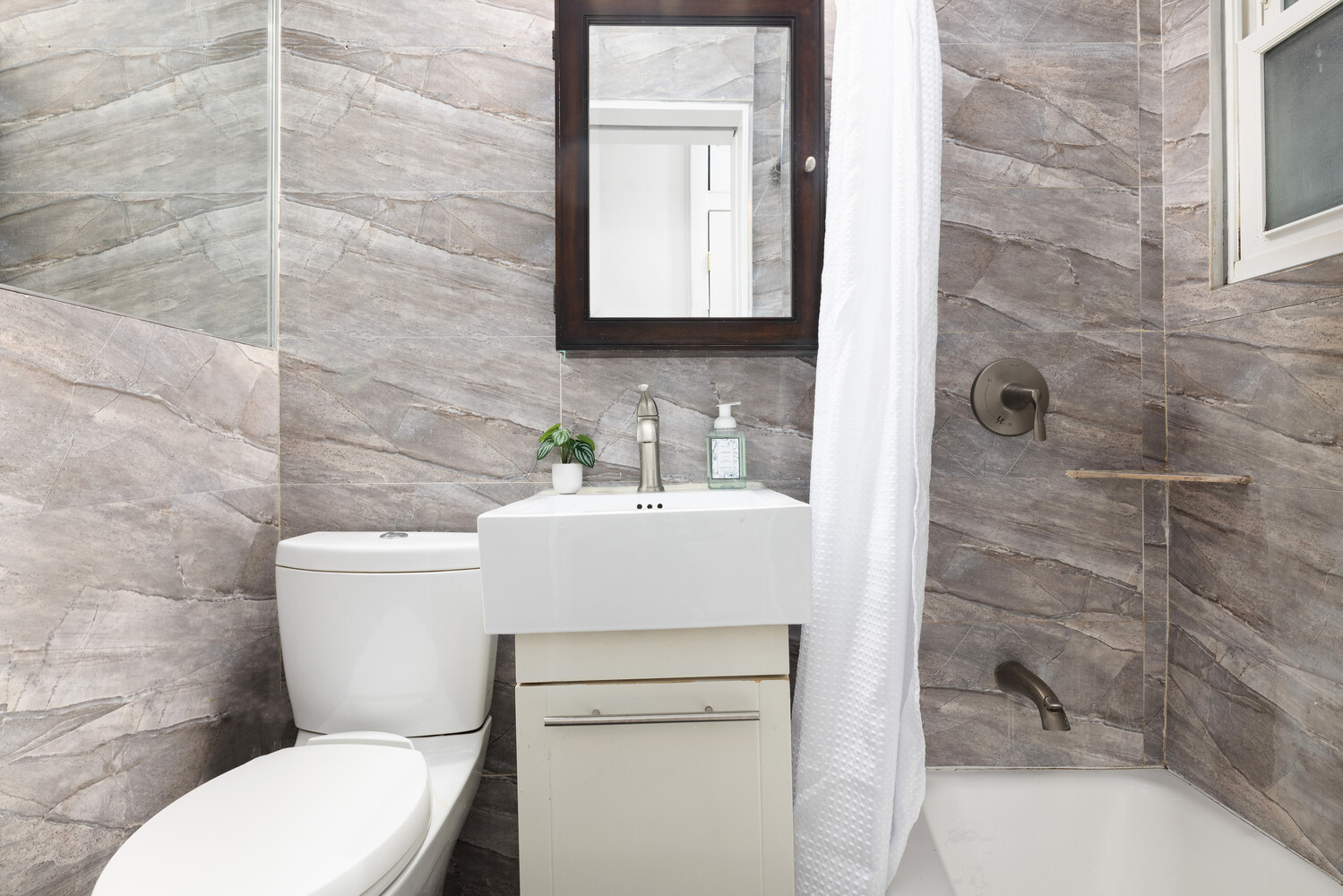 66 West 84th Street, Unit 3F Manhattan, NY 10024 - Photo 5 of 6 a bathroom with a toilet sink and mirror