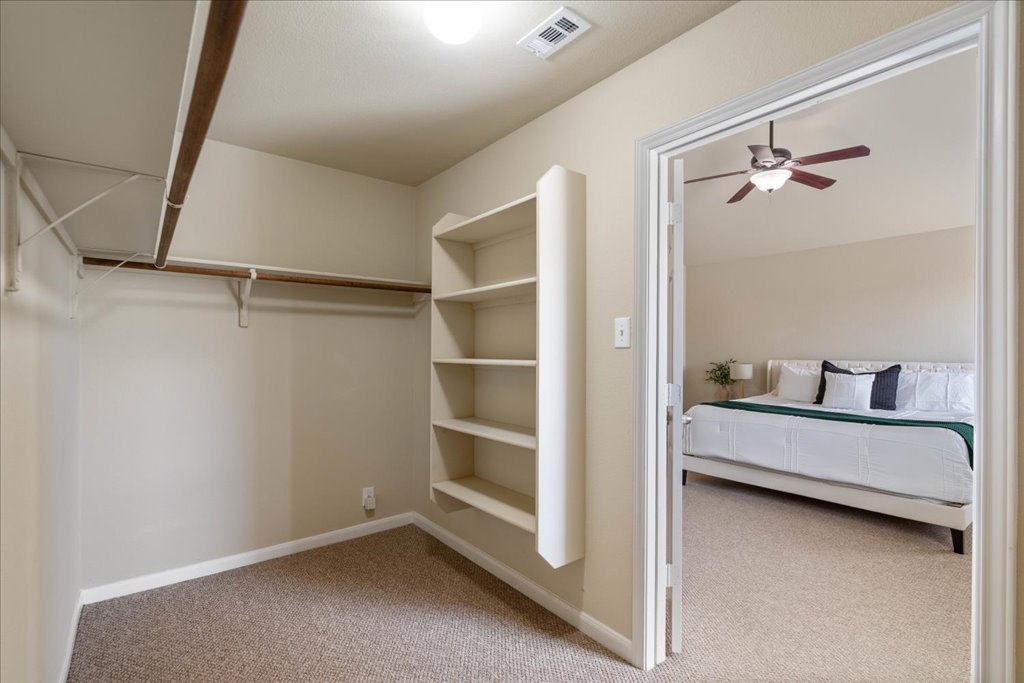 1810 Laminar Creek Road Cedar Park, TX 78613 - Photo 16 of 25 a view of a bedroom with a bed and a ceiling fan