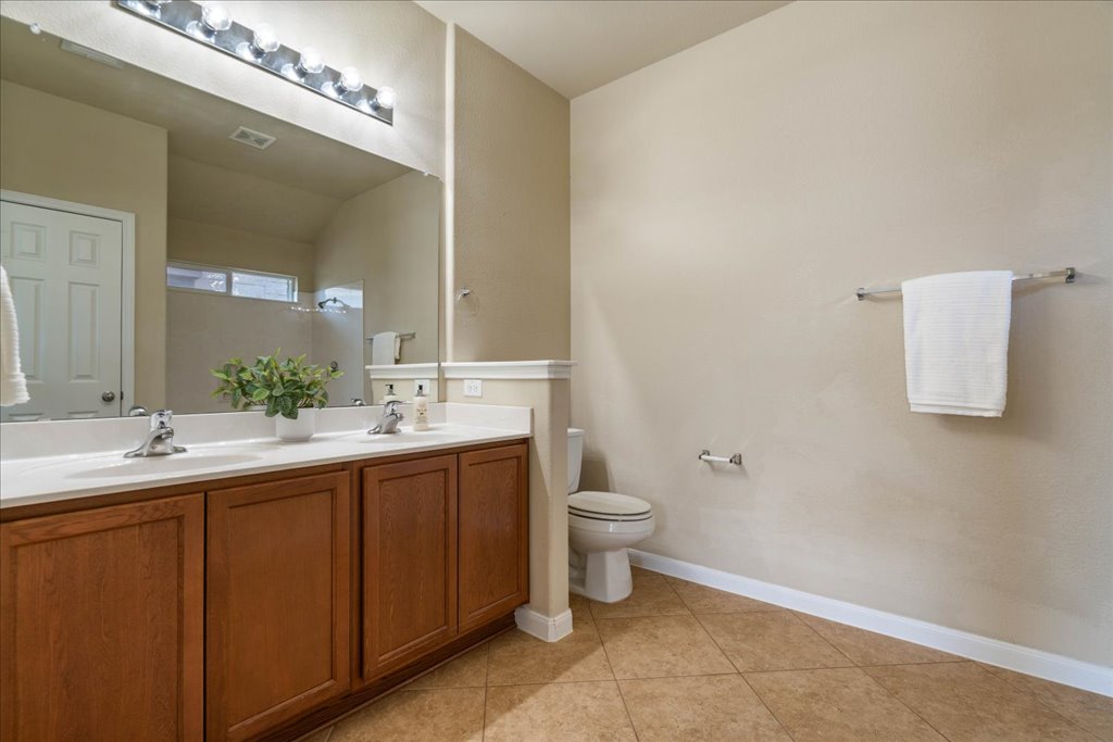 1810 Laminar Creek Road Cedar Park, TX 78613 - Photo 17 of 25 a bathroom with a toilet sink and mirror