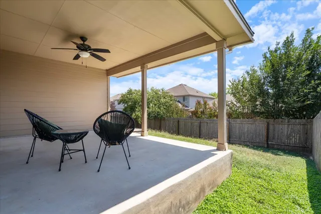 a balcony with table and chairs