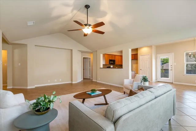 a living room with furniture and a potted plant