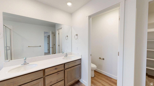 777 Pheasantbrook Drive, Unit 2B Centerville, UT 84014 - Photo 10 of 42 Dual vanity with white undermount sinks, chrome fixtures, and a light-toned countertop