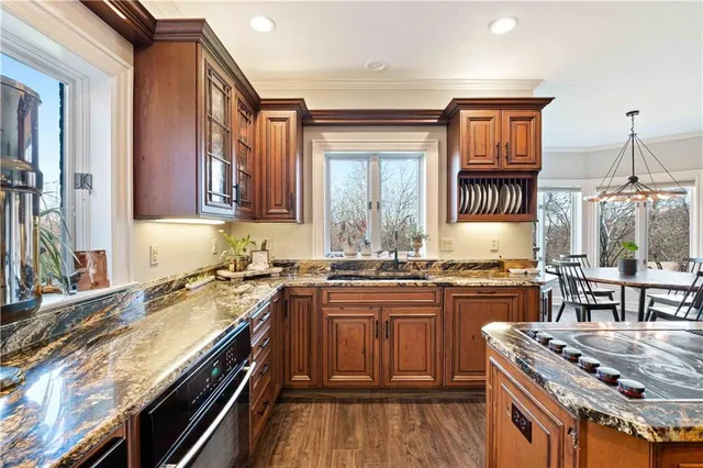 a kitchen with stainless steel appliances granite countertop a stove and refrigerator