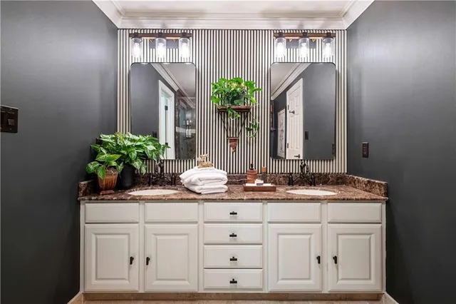 a spacious bathroom with a double vanity sink and a mirror