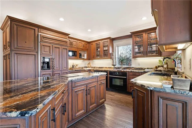 a kitchen with stainless steel appliances granite countertop a stove and a refrigerator