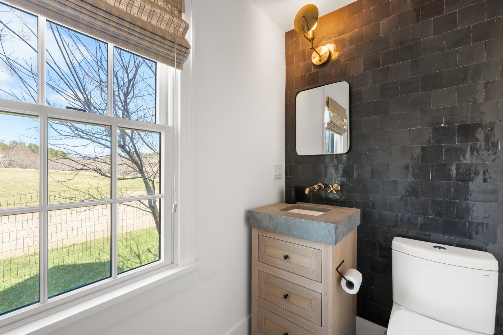 174 Cliff Road Nantucket, MA 02554 - Photo 22 of 49 a bathroom with a toilet sink vanity and mirror