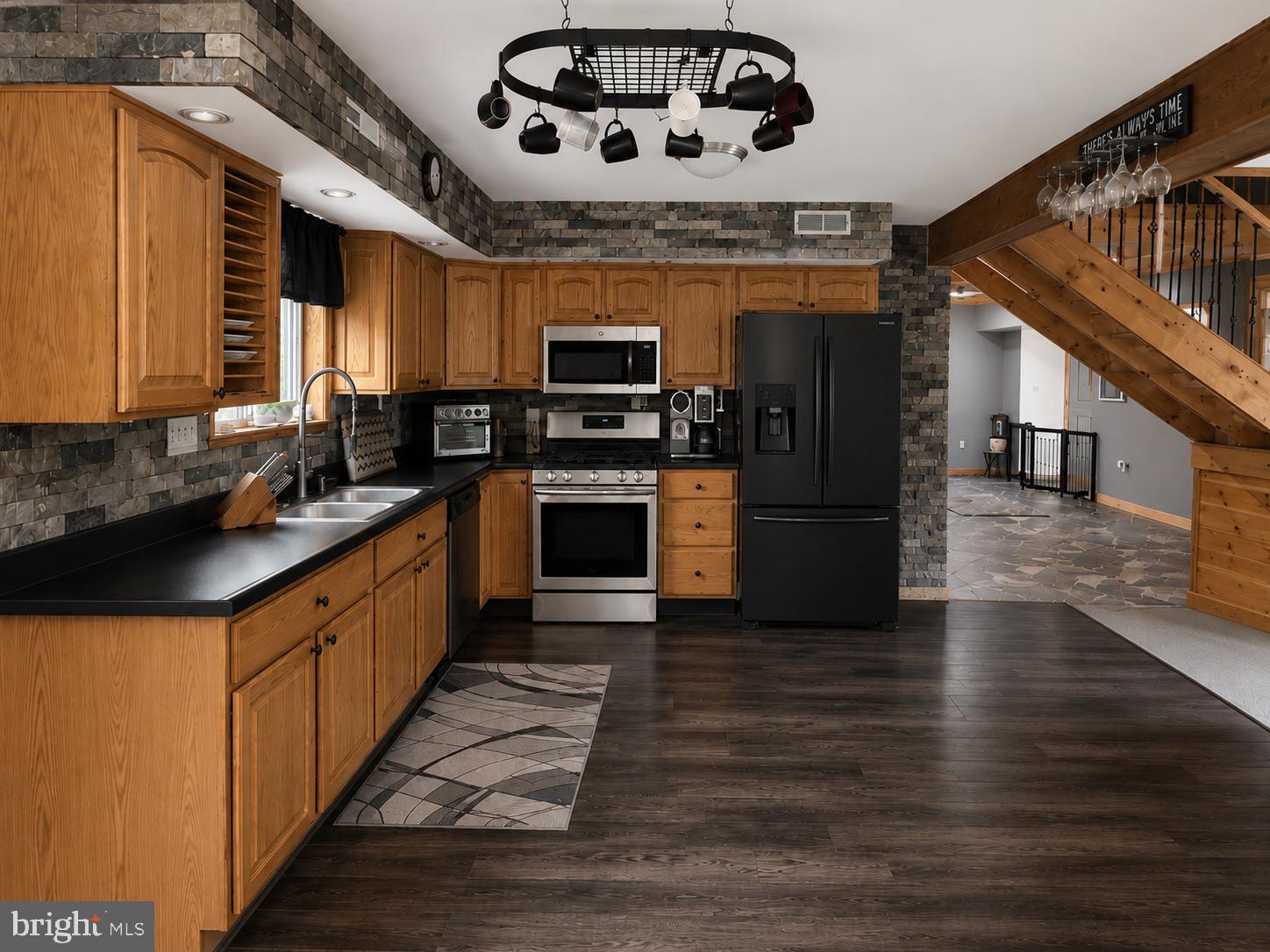 303 Flickerwood Road Kane, PA 16735 - Photo 4 of 25 a large kitchen with stainless steel appliances granite countertop a stove and a sink