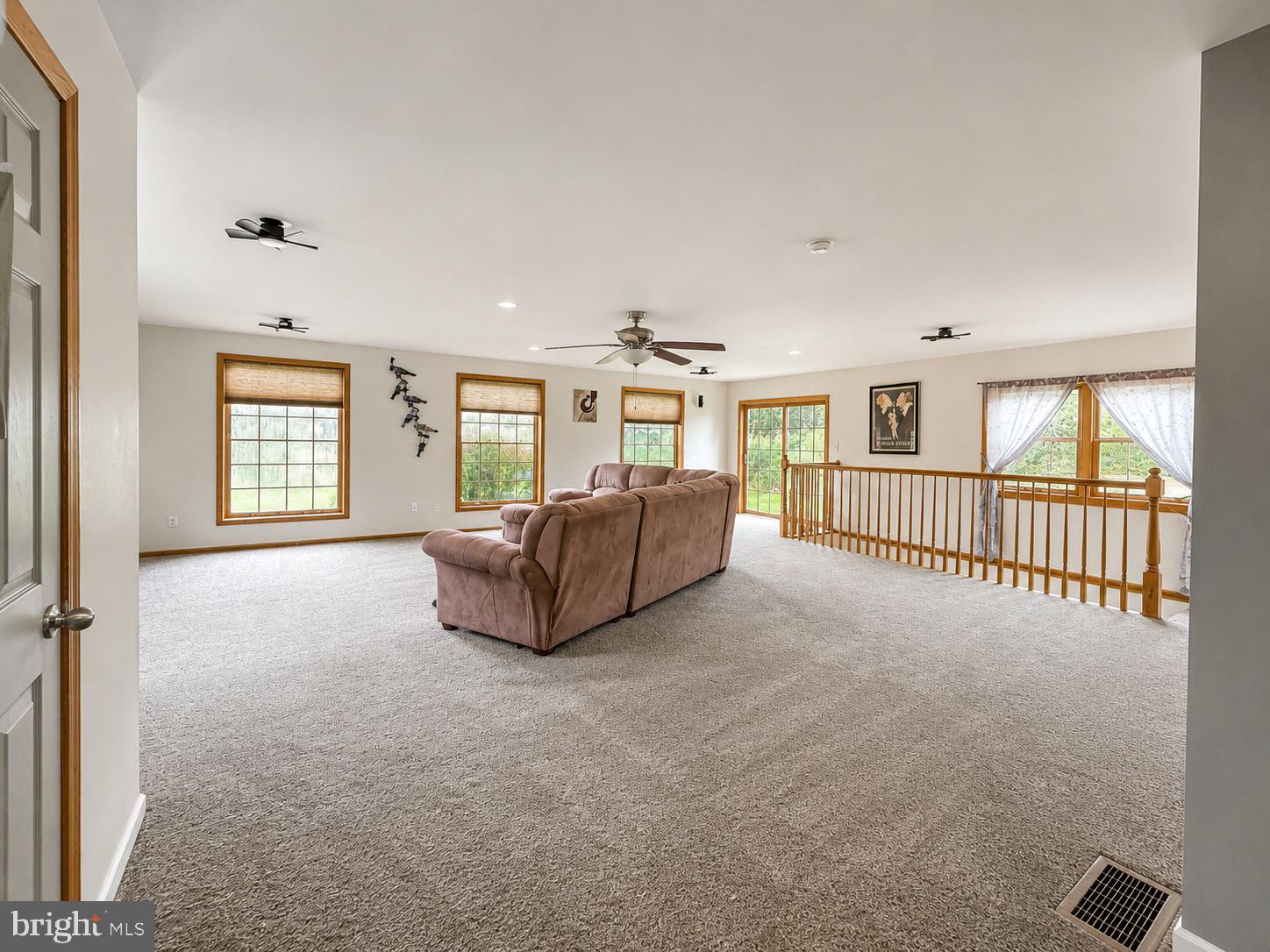 303 Flickerwood Road Kane, PA 16735 - Photo 7 of 25 wooden floor fireplace and windows in an empty room