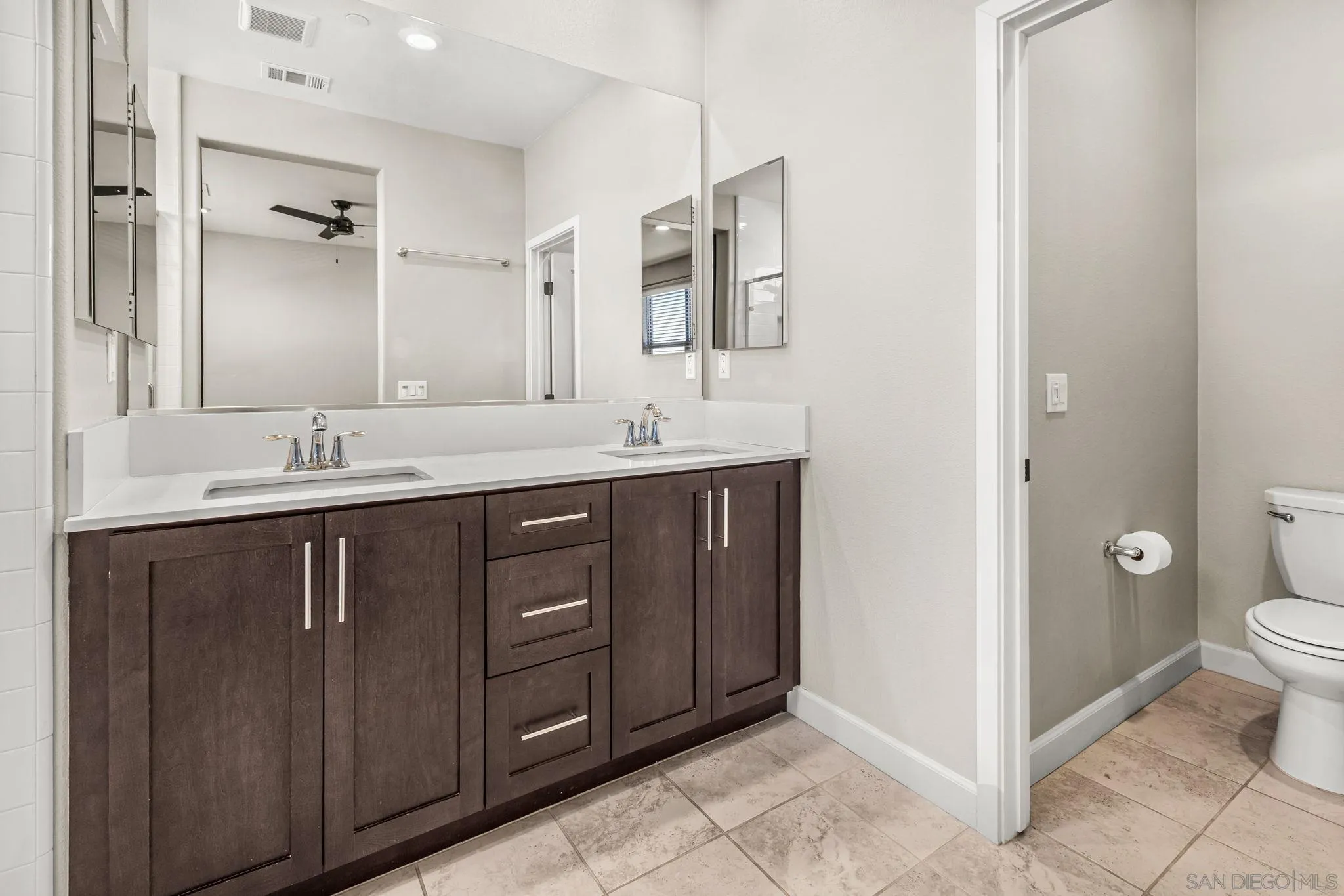1922 Strata Street, Unit 5 Chula Vista, CA 91915 - Photo 13 of 45 a bathroom with a granite countertop sink toilet and mirror
