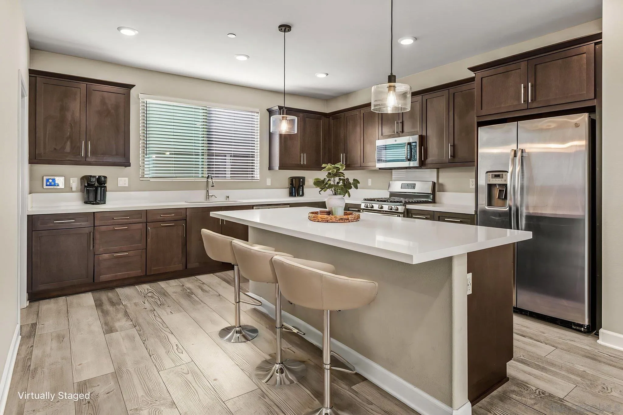 1922 Strata Street, Unit 5 Chula Vista, CA 91915 - Photo 2 of 45 a kitchen with stainless steel appliances granite countertop a sink a stove a refrigerator cabinets and chairs