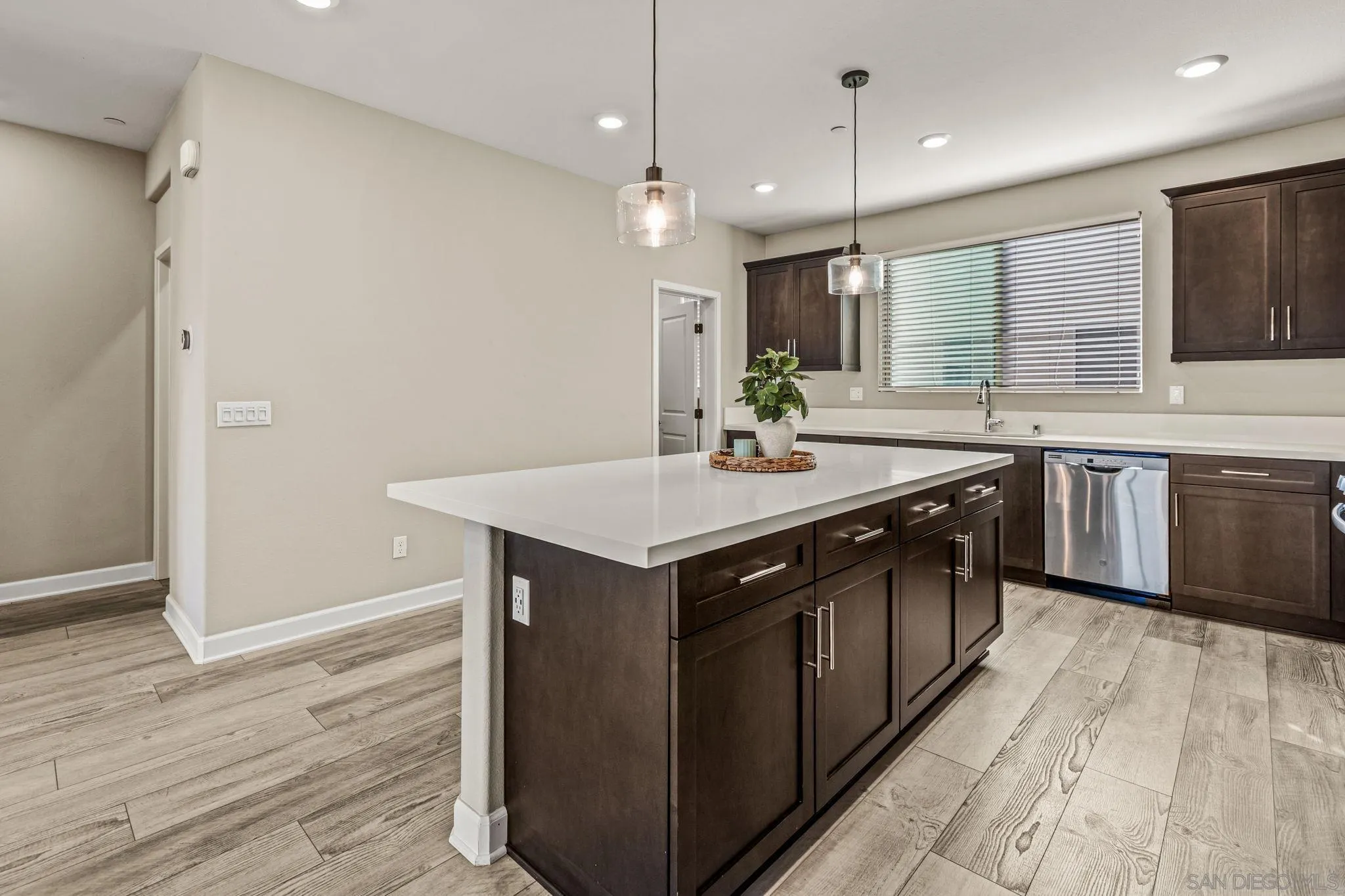 1922 Strata Street, Unit 5 Chula Vista, CA 91915 - Photo 5 of 45 a kitchen with a sink cabinets and wooden floor