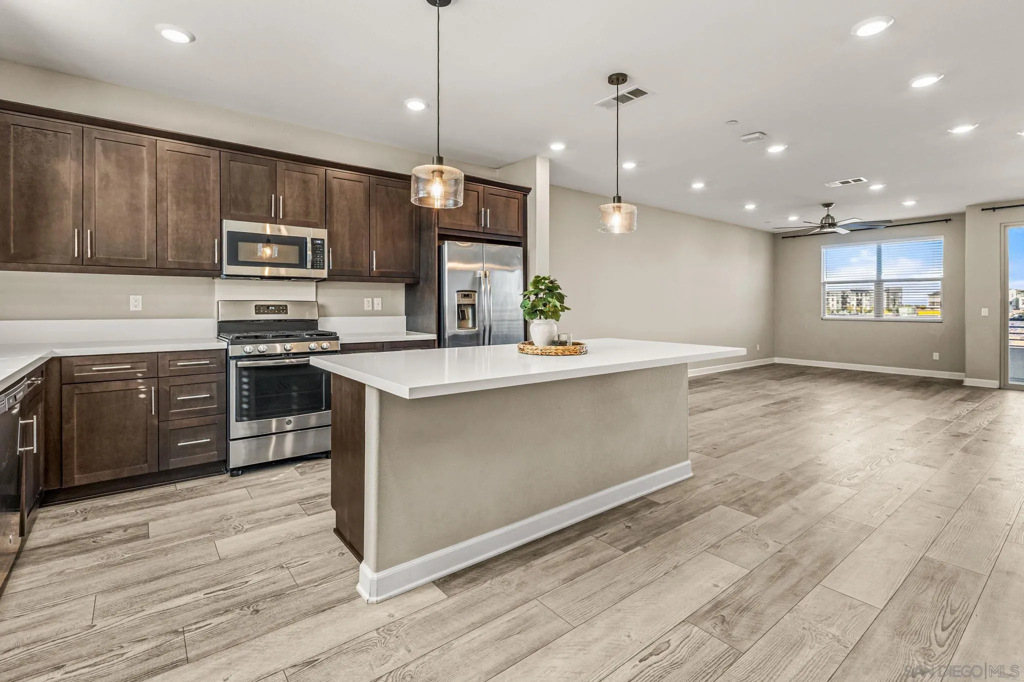 1922 Strata Street, Unit 5 Chula Vista, CA 91915 - Photo 6 of 45 a large kitchen with stainless steel appliances granite countertop a stove a sink and a microwave
