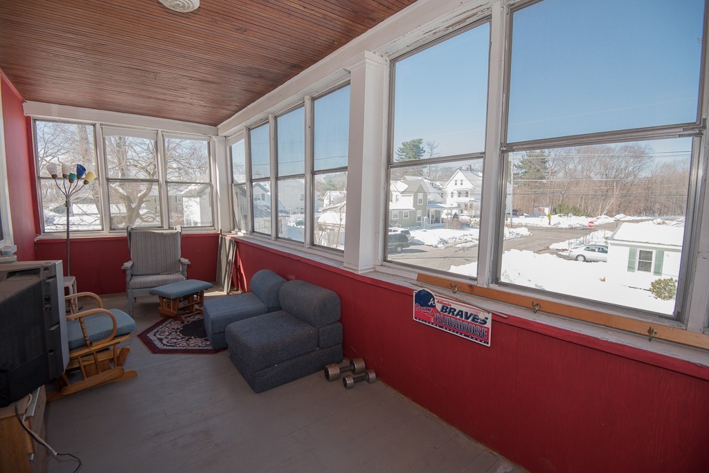 7-9 Boynton Street Clinton, MA 01510 - Photo 13 of 28 a living room with furniture and a floor to ceiling window