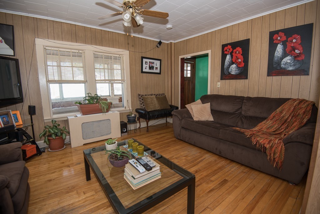 7-9 Boynton Street Clinton, MA 01510 - Photo 16 of 28 a living room with furniture two window and a flat screen tv