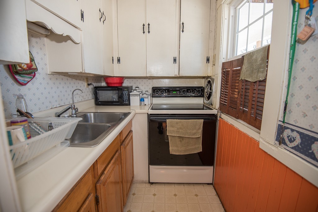 7-9 Boynton Street Clinton, MA 01510 - Photo 17 of 28 a kitchen with stainless steel appliances granite countertop a sink stove and white cabinets