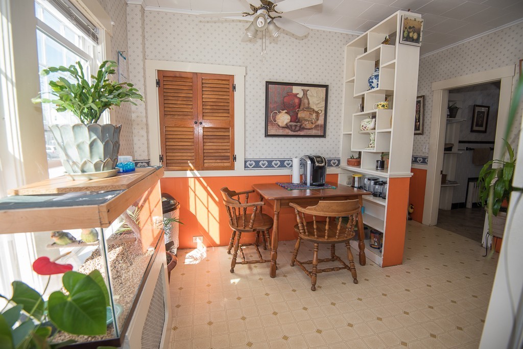 7-9 Boynton Street Clinton, MA 01510 - Photo 18 of 28 a dining room with furniture potted plants and a fireplace