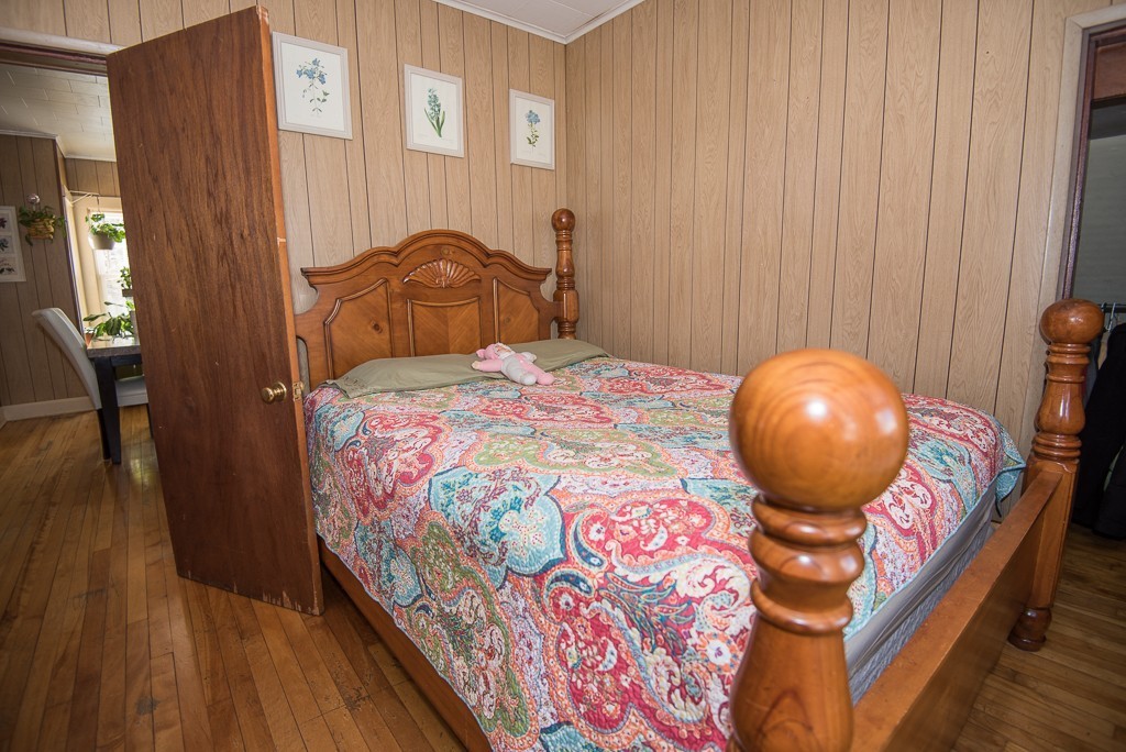 7-9 Boynton Street Clinton, MA 01510 - Photo 20 of 28 a bedroom with a bed and a chandelier