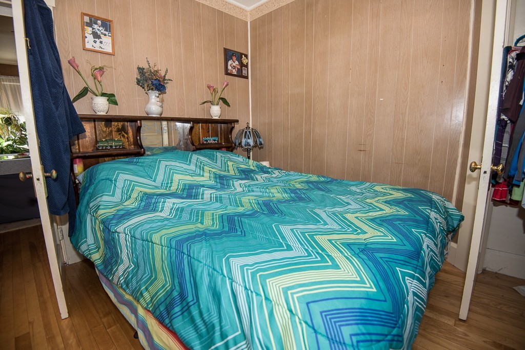 7-9 Boynton Street Clinton, MA 01510 - Photo 7 of 28 a bed sitting in a bedroom next to a window