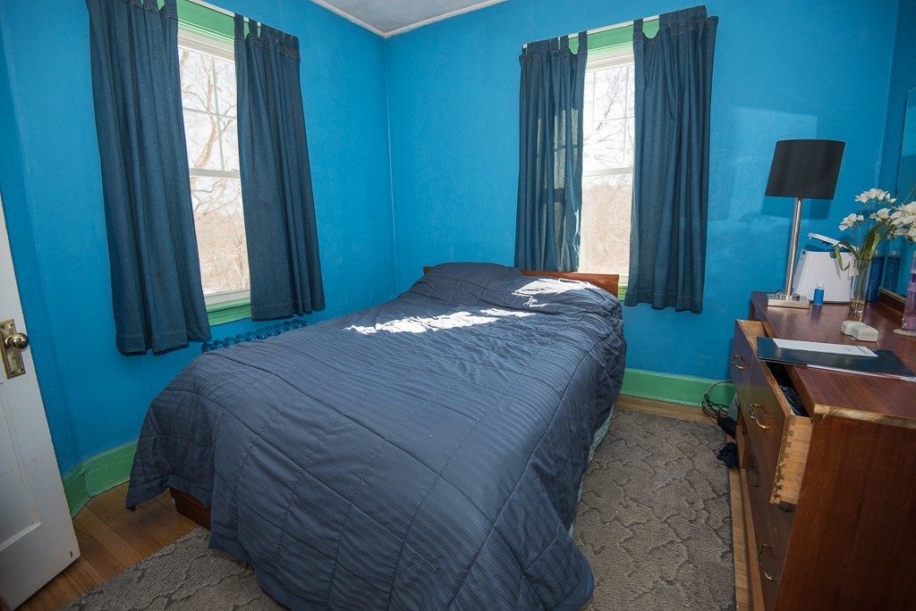 7-9 Boynton Street Clinton, MA 01510 - Photo 8 of 28 a bed sitting in a bedroom next to a window