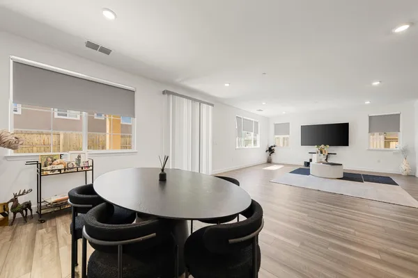 a living room with dining room and wooden floor