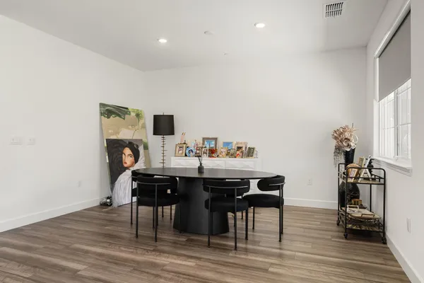 a view of a dining room with furniture and wooden floor
