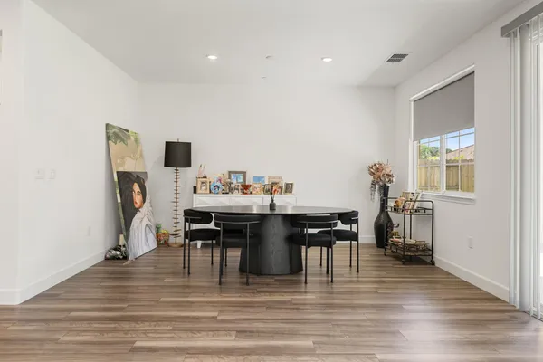a view of a dining room with furniture and wooden floor