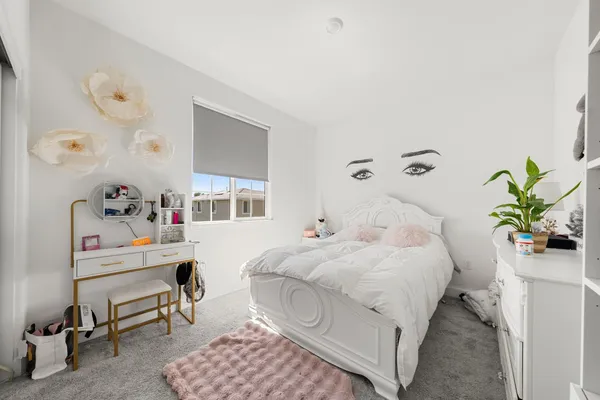 a bedroom with a bed and a table in it