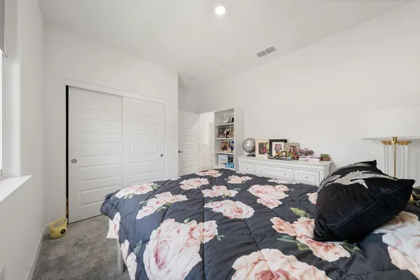 a bedroom with a bed and a cabinets