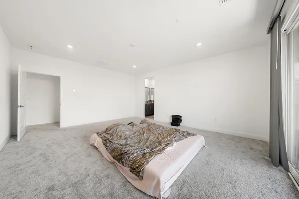 a bedroom with a bed and a night stand