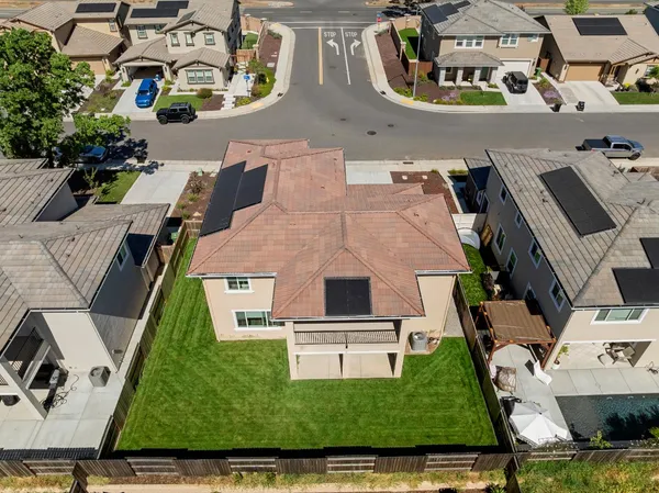 an aerial view of multiple houses with yard