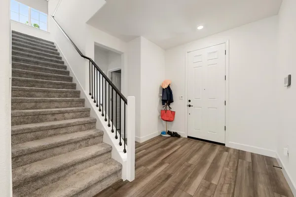 a view of a room with wooden floor and staircase