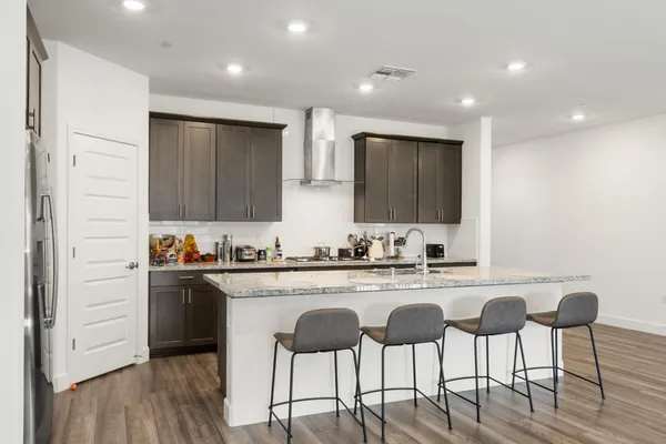 a kitchen with cabinets and chairs