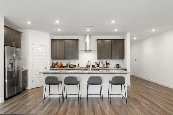 a kitchen with sink cabinets and wooden floor