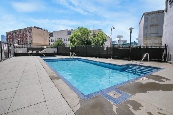 566 Commonwealth Avenue, Unit 1003 Boston, MA 02215 - Photo 13 of 14 a swimming pool with outdoor seating and yard