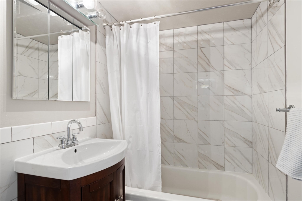 566 Commonwealth Avenue, Unit 1003 Boston, MA 02215 - Photo 5 of 14 a bathroom with a sink and a mirror