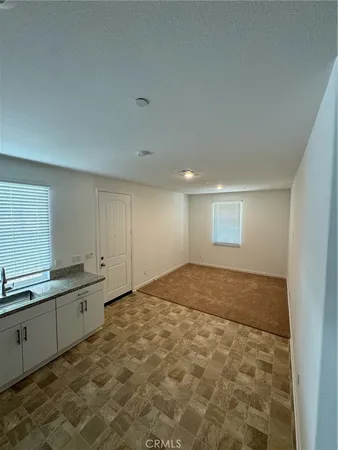 a view of a kitchen with a sink and cabinets
