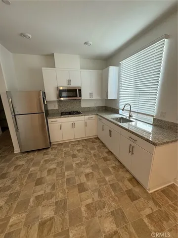 a kitchen with sink cabinets and window