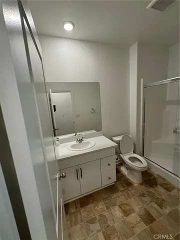 a bathroom with a double vanity sink toilet and shower