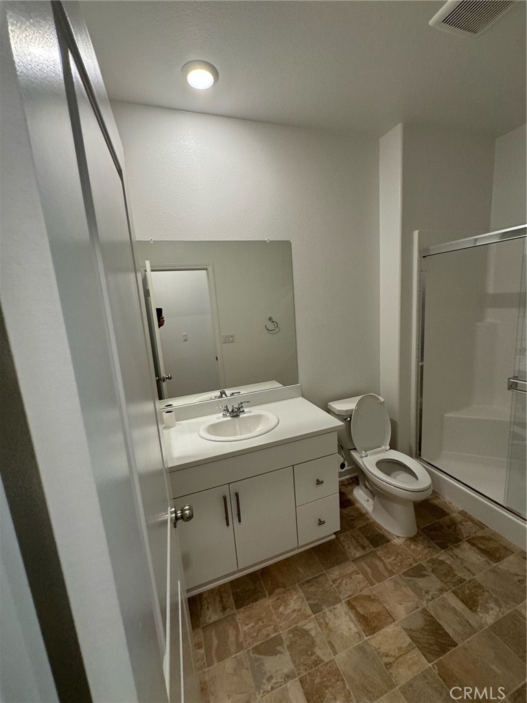 25685 Branson Lane Homeland, CA 92548 - Photo 9 of 13 a bathroom with a double vanity sink toilet and shower