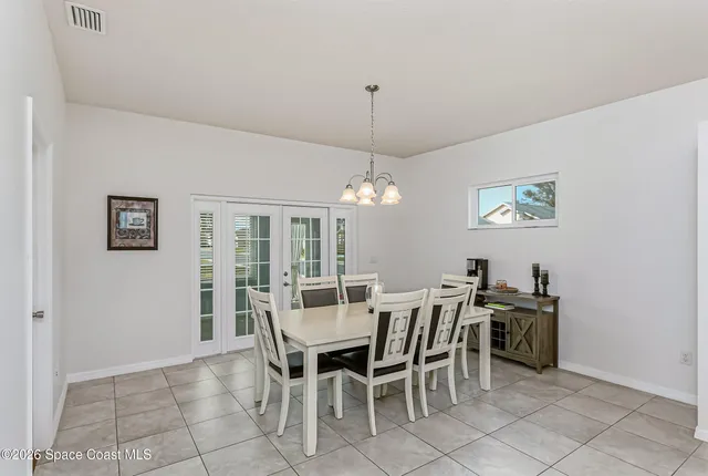a view of a dining room with furniture and chandelier