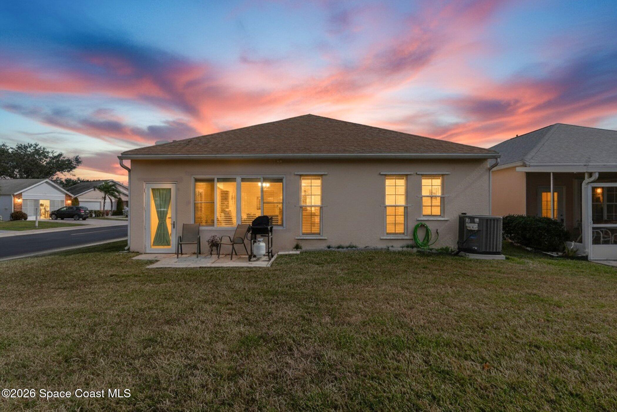 1069 South Fork Circle Melbourne, FL 32901 - Photo 24 of 52 a front view of a house with a garden and yard